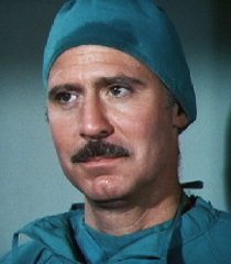 Dr. Rudy Wells (Alan Oppenheimer)